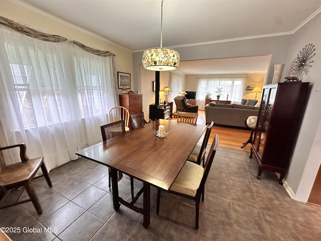 dining room with tile patterned floors and ornamental molding