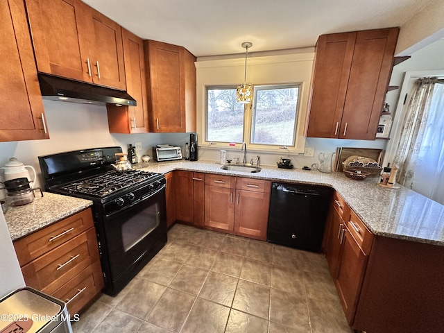 kitchen with light stone countertops, under cabinet range hood, a peninsula, black appliances, and a sink