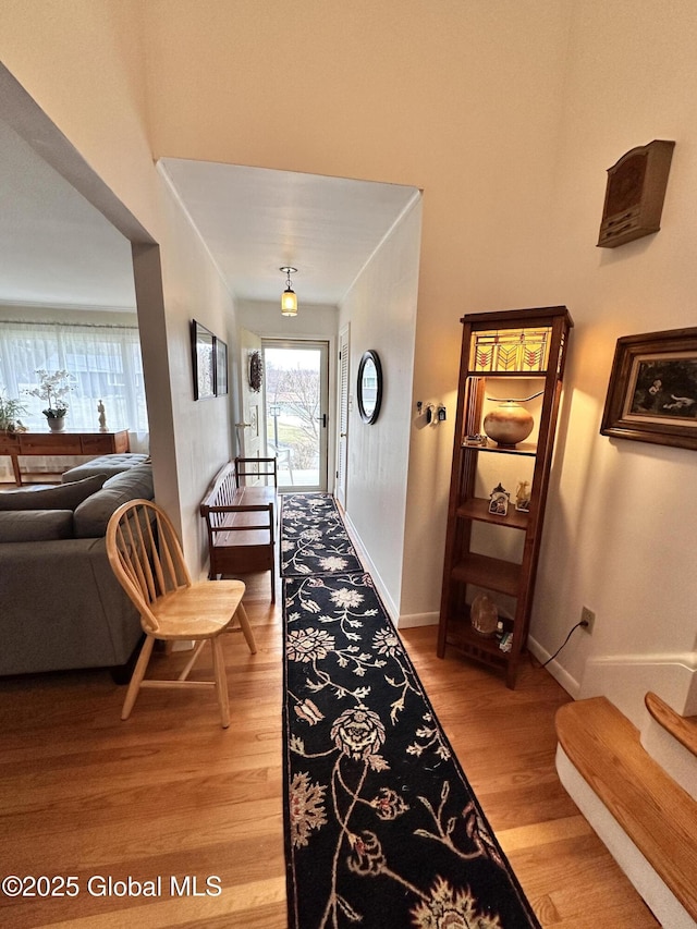 hallway with baseboards and light wood-style floors