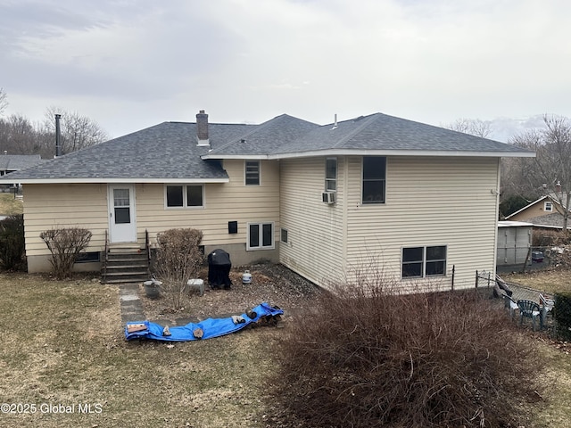 rear view of property with cooling unit, a chimney, roof with shingles, and fence
