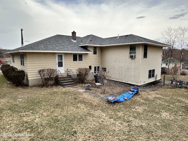 rear view of house with cooling unit, fence, a yard, a chimney, and a shingled roof