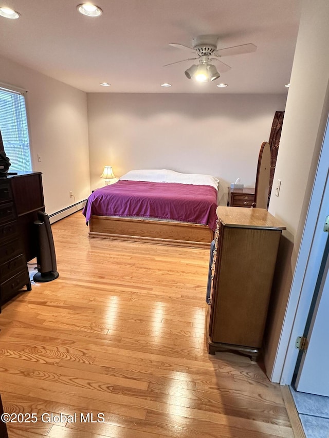 bedroom featuring recessed lighting, light wood-style floors, and baseboard heating