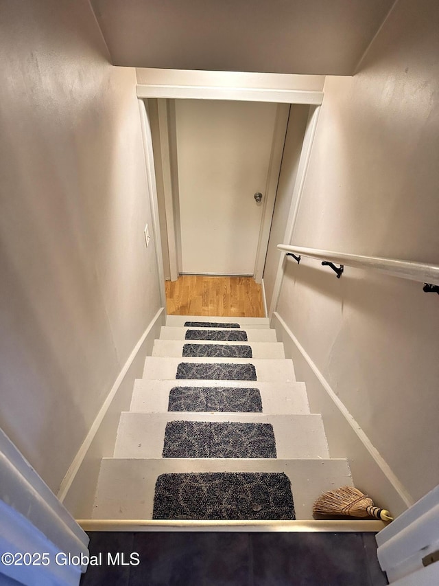 stairs featuring wood finished floors