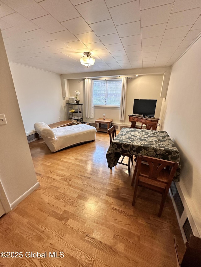 bedroom featuring light wood-style flooring and baseboards