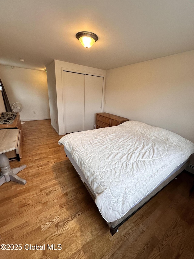 bedroom featuring light wood-style flooring and a closet