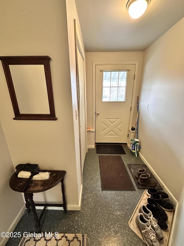 doorway to outside with baseboards