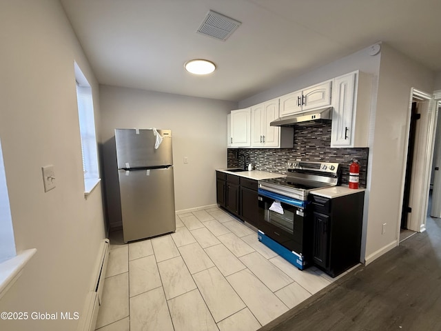 kitchen featuring visible vents, under cabinet range hood, light countertops, stainless steel appliances, and white cabinetry