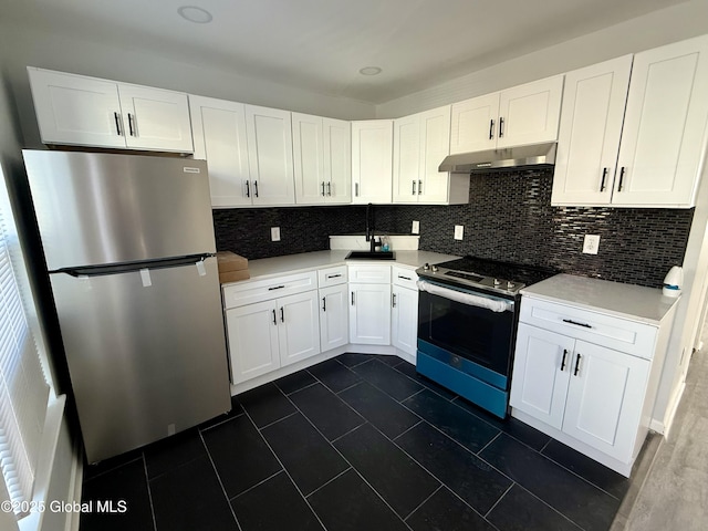 kitchen featuring under cabinet range hood, white cabinetry, stainless steel appliances, and tasteful backsplash