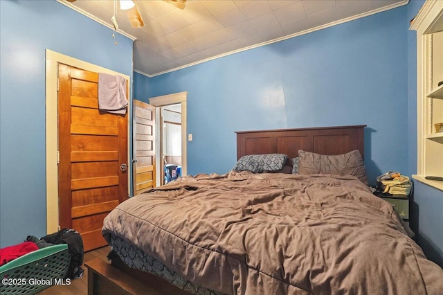 bedroom featuring ceiling fan and crown molding