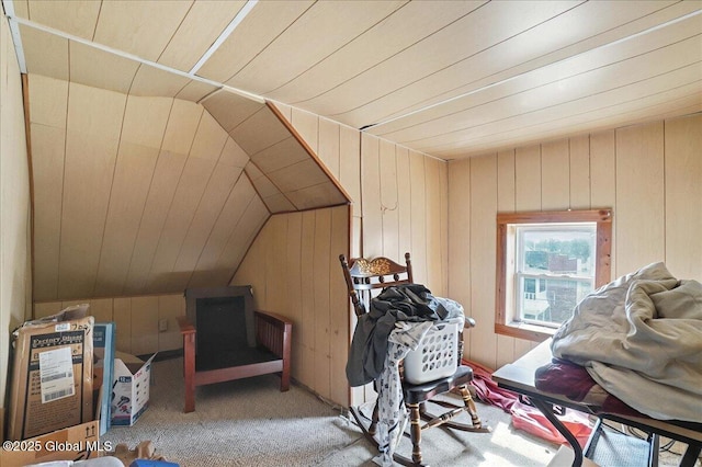 additional living space featuring wooden walls, carpet flooring, wood ceiling, and lofted ceiling