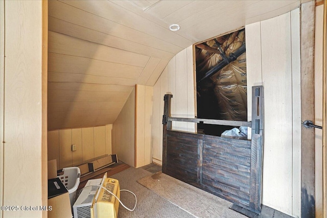 interior space with vaulted ceiling, wooden walls, and wood ceiling