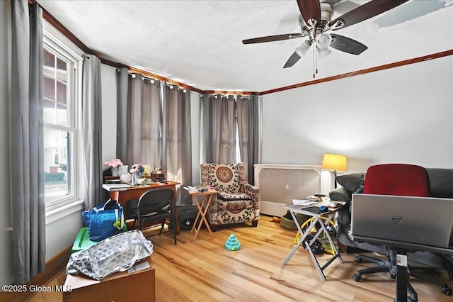 home office with a textured ceiling, ceiling fan, and wood finished floors