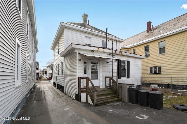 rear view of house with fence