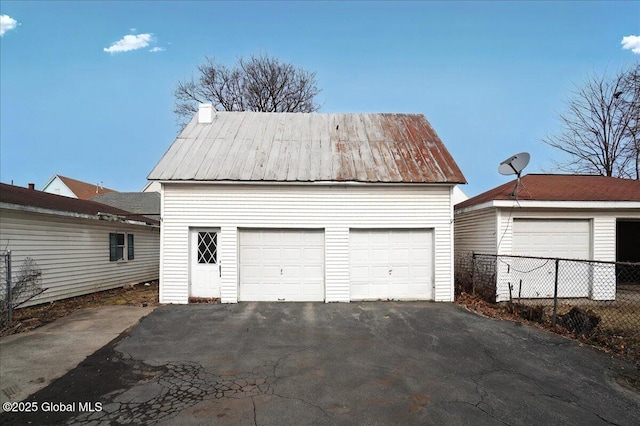 detached garage featuring fence