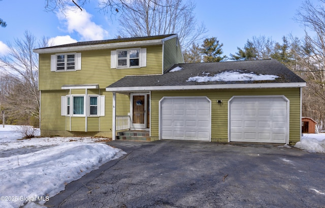 view of front of home featuring aphalt driveway and a garage