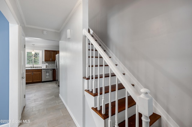 staircase featuring crown molding