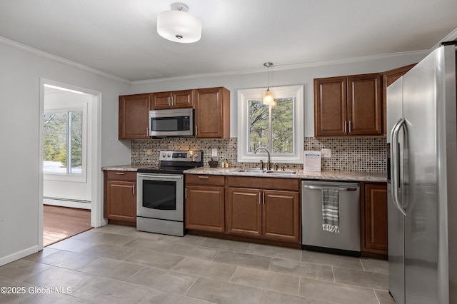 kitchen featuring baseboard heating, a healthy amount of sunlight, stainless steel appliances, and a sink