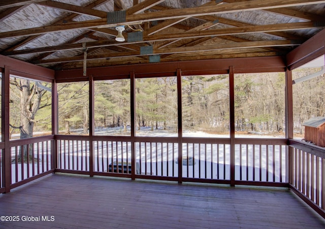 unfurnished sunroom featuring lofted ceiling