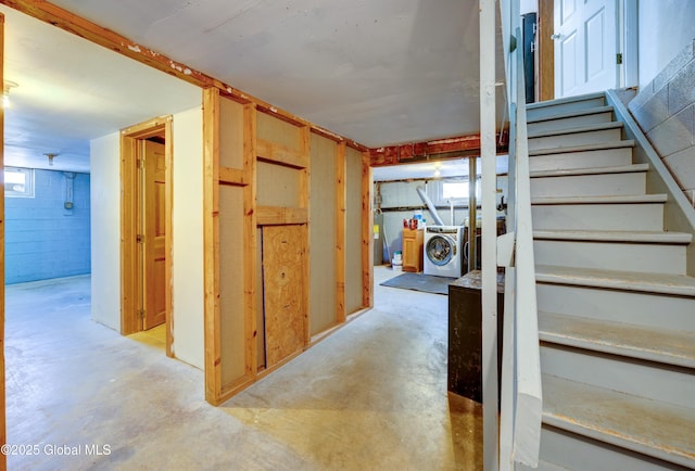 interior space featuring a wealth of natural light, washer / clothes dryer, and concrete flooring