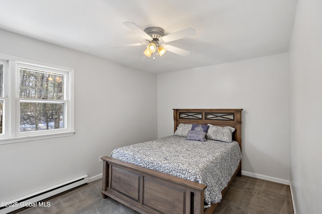 carpeted bedroom with baseboard heating, a ceiling fan, and baseboards