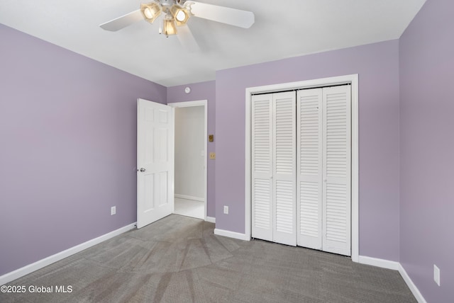 unfurnished bedroom featuring a closet, baseboards, carpet floors, and ceiling fan