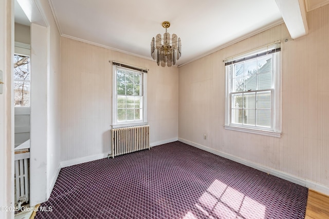 unfurnished room featuring a notable chandelier, crown molding, radiator heating unit, and baseboards