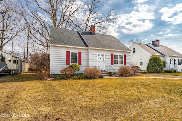 cape cod-style house featuring a chimney, a front yard, and a shingled roof