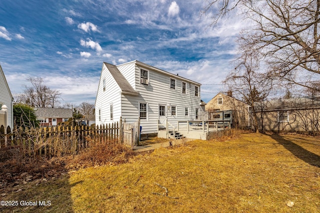 rear view of property with fence