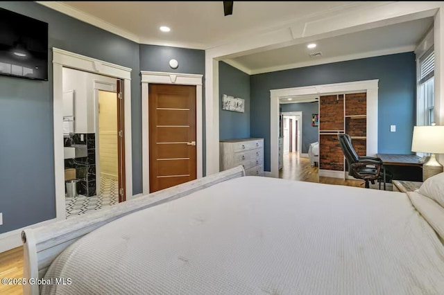 bedroom with crown molding, recessed lighting, wood finished floors, and baseboards