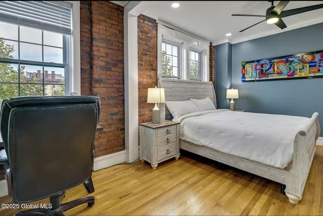 bedroom with brick wall, baseboards, ceiling fan, recessed lighting, and light wood-style flooring