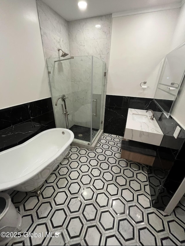 full bathroom featuring vanity, a soaking tub, tile walls, and a shower stall