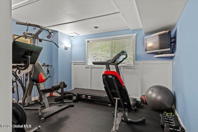 workout room featuring a wainscoted wall and visible vents