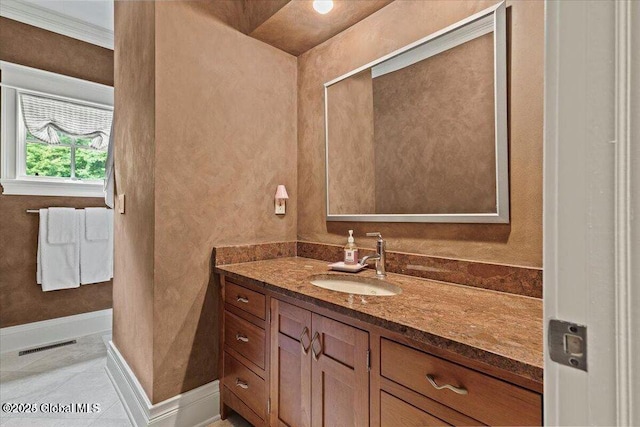 bathroom with visible vents, vanity, and baseboards