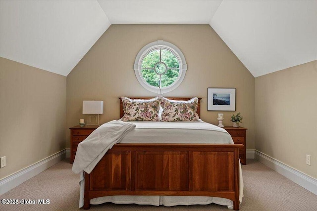 bedroom with baseboards, lofted ceiling, and light carpet