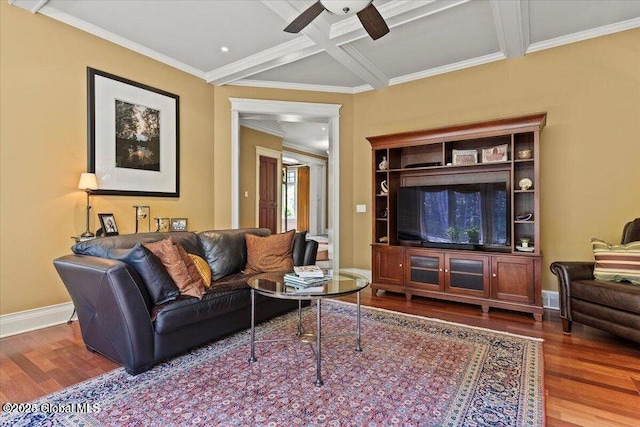 living area with ornamental molding, coffered ceiling, wood finished floors, baseboards, and ceiling fan