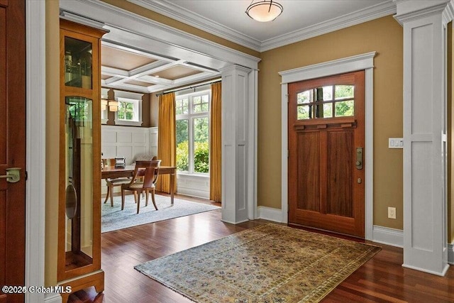 foyer with a wealth of natural light, decorative columns, coffered ceiling, and crown molding