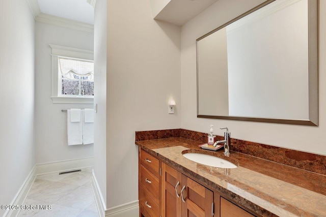 bathroom with vanity, baseboards, tile patterned flooring, and ornamental molding