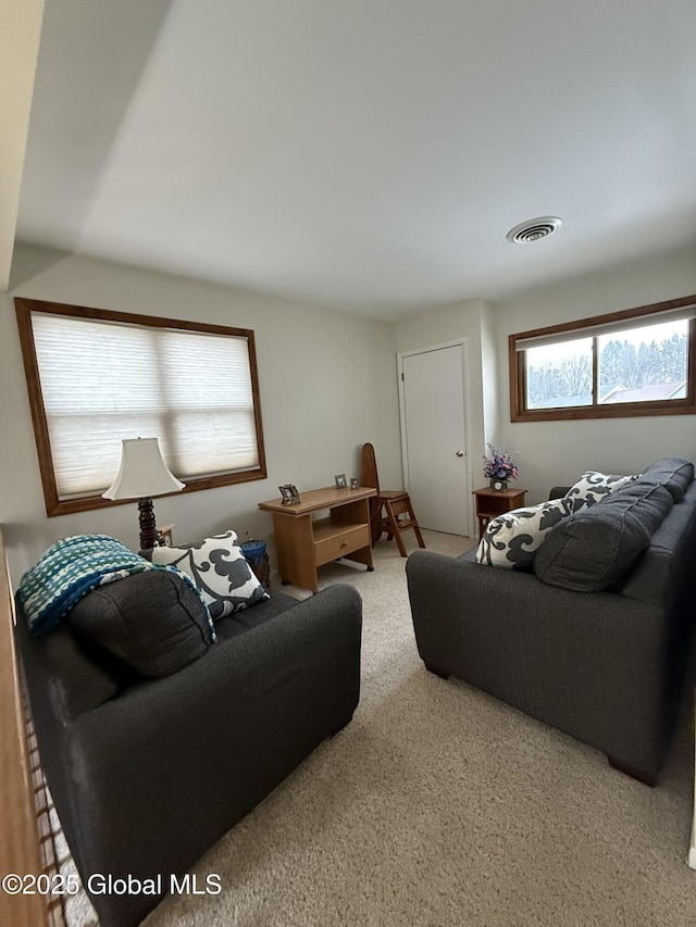 living room featuring visible vents and carpet flooring