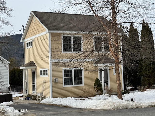 view of front of property with entry steps and roof with shingles