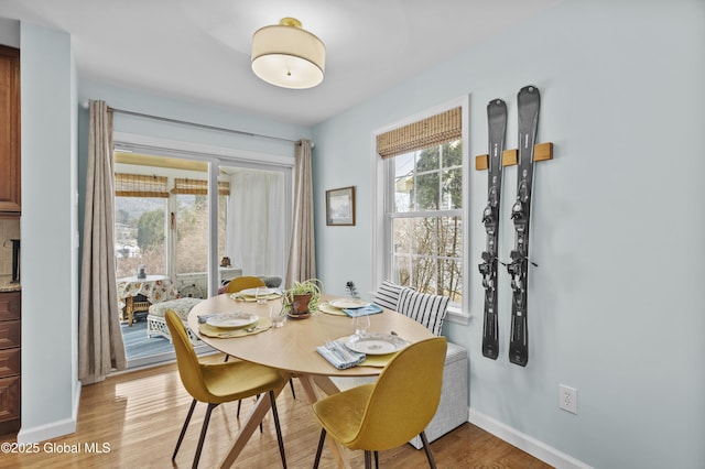 dining room with light wood-style flooring and baseboards