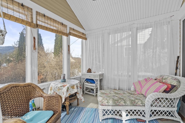 sunroom / solarium featuring vaulted ceiling