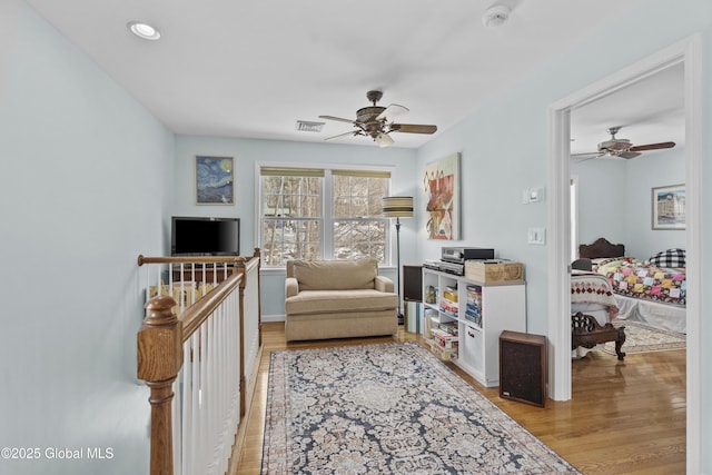 sitting room with recessed lighting, visible vents, light wood-style flooring, and a ceiling fan