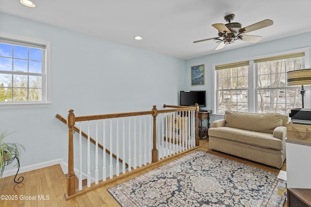 living area with recessed lighting, baseboards, a ceiling fan, and wood finished floors