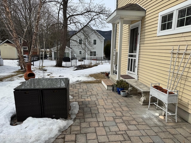 snow covered patio with fence