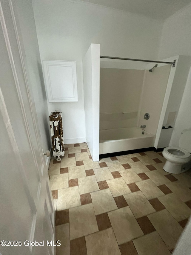 bathroom with shower / washtub combination and toilet