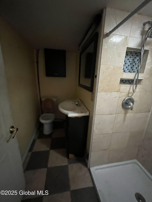 full bath with a shower stall, toilet, and a sink