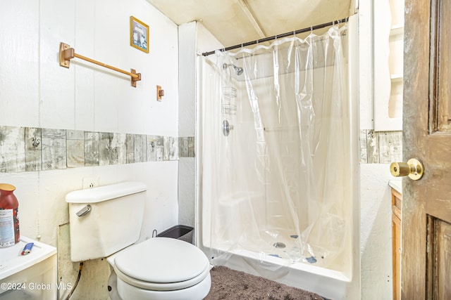 bathroom featuring a shower stall, toilet, and tile walls