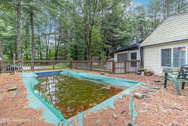 view of pool with a deck and a fenced in pool