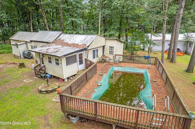 view of pool with a lawn and a deck