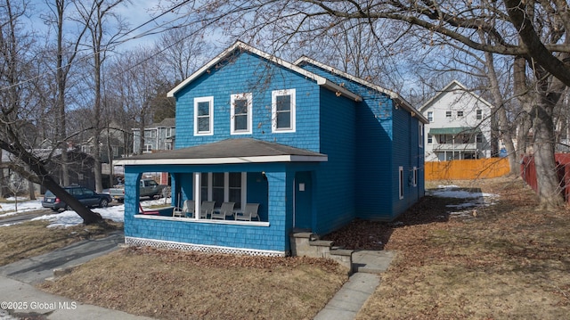 view of front of property with fence and covered porch